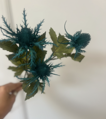 Artificial teal Eryngium thistle by the stem